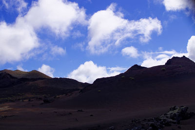 View of desert against cloudy sky