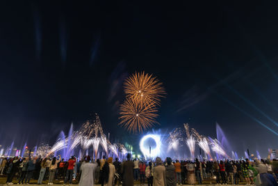 Crowd watching fireworks and celebrating new year eve