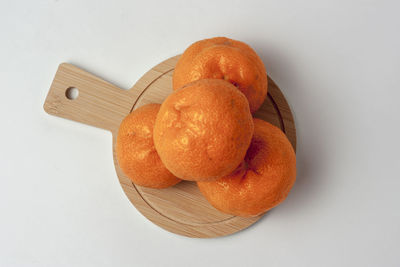 High angle view of orange fruit on white table