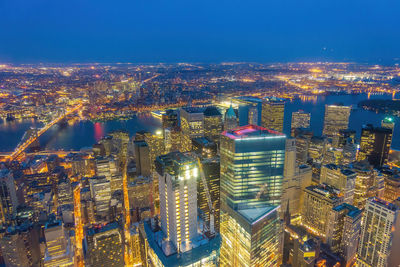 High angle view of city lit up at night