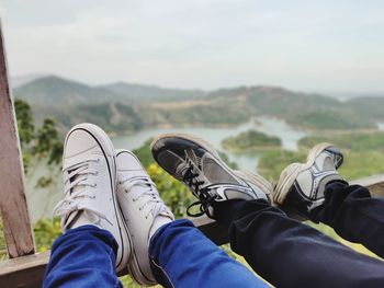 Low section of man relaxing on mountain