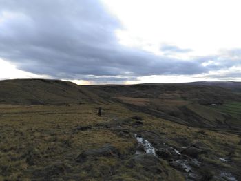 Scenic view of landscape against cloudy sky