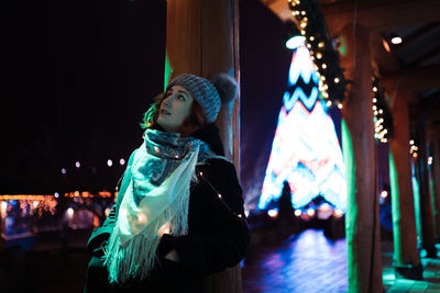 Woman wearing knit hat standing outdoors