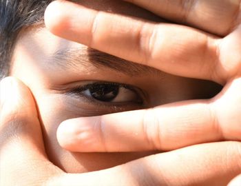 Close-up portrait of woman with hands