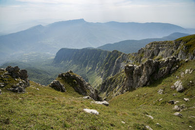 Scenic view of landscape and mountains against sky