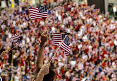 Close-up of american flags against blurred background