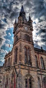 Low angle view of church against cloudy sky