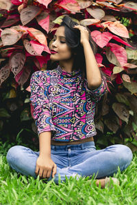 Full length of woman sitting on leaves