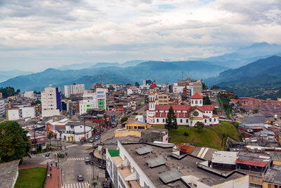 High angle view of cityscape against cloudy sky