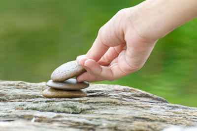 Close-up of hand stacking stones