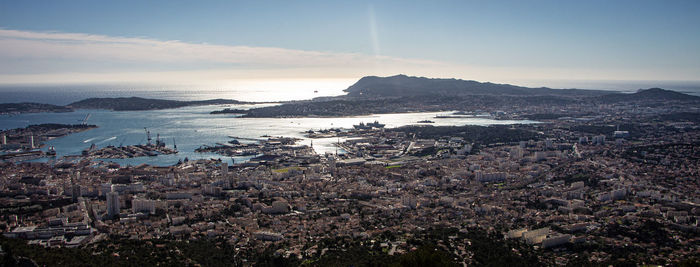 High angle view of townscape by sea against sky