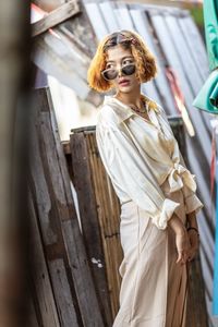 Young woman looking down while standing outdoors