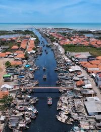 High angle view of harbor by buildings in city