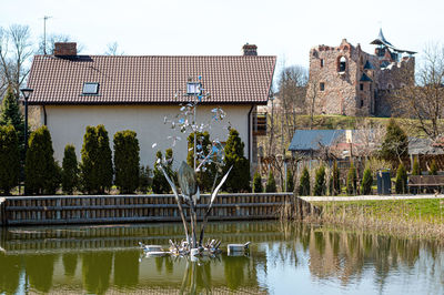 Private house with a pond and a fountain on the background of an old castle, dobele, latvia