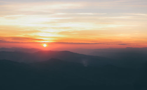 Scenic view of silhouette mountains against sky during sunset