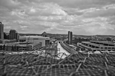 Tilt-shift image of cityscape against cloudy sky