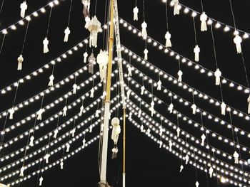 Low angle view of illuminated carousel at night