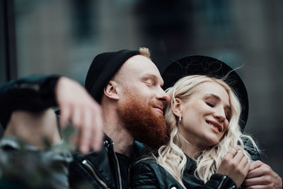 Portrait of young couple kissing outdoors