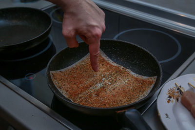 Close-up of person preparing food in kitchen