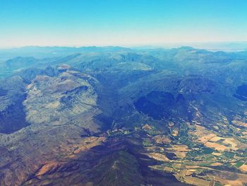 Scenic view of mountains against blue sky