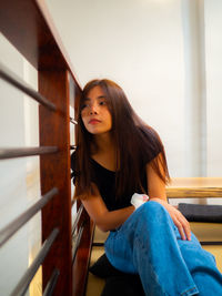Portrait of woman sitting in corridor