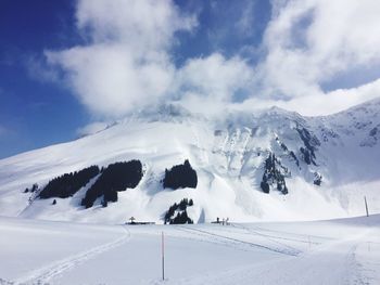 Scenic view of snow covered mountains against sky