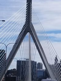 Low angle view of suspension bridge against sky