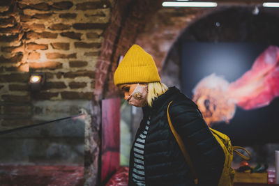 Midsection of man standing against wall during winter