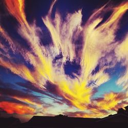 Low angle view of cloudy sky at sunset