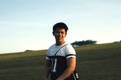 Portrait of woman standing on field