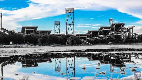 Reflection of building on sea against sky