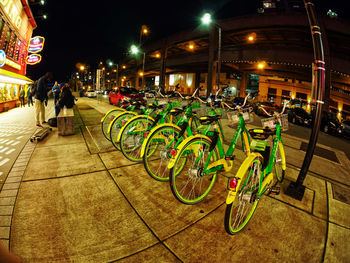 Bicycles in illuminated city at night