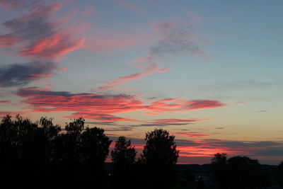 Silhouette trees against romantic sky at sunset