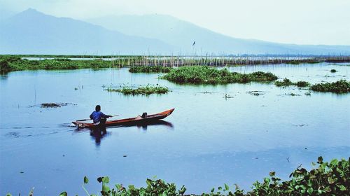 Scenic view of lake with mountains in background