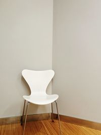 Close-up of chair on hardwood floor at home