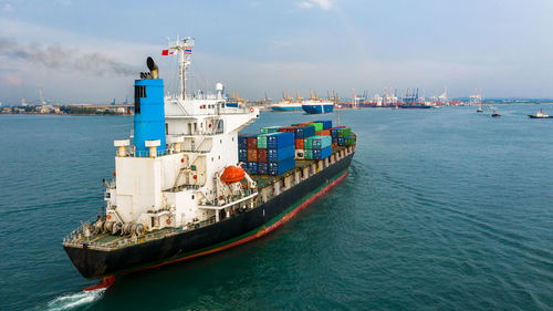 Container ship carrying container box in import export to commercial port, global business cargo.