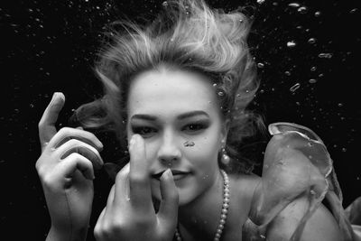 Portrait of young woman in water