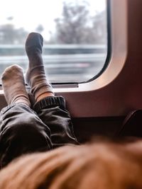 Low section of man relaxing in bus