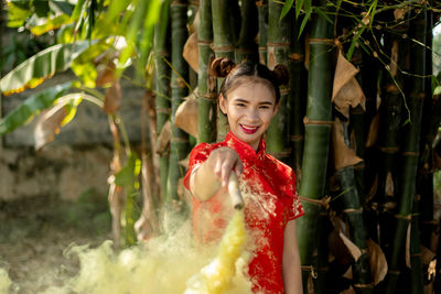 Portrait of smiling young woman standing outdoors