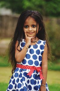 Portrait of a smiling girl standing outdoors