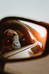 Rear-view mirror reflection of the great big sur sunset