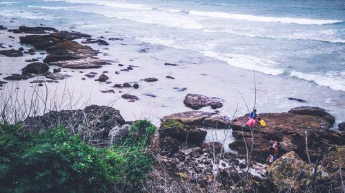 High angle view of rocks by sea