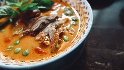Roasted duck with pineapple,sweet basil leaves and chili peppers in red curry, thai food style.