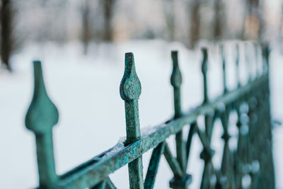 Close-up of metal fence during winter