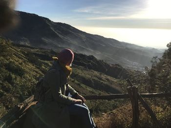 Man looking at mountain range