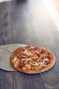 High angle view of grilled pizza on wooden table