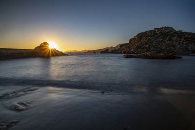 Scenic view of sea against clear sky during sunset