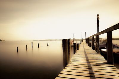 Pier on sea against clear sky