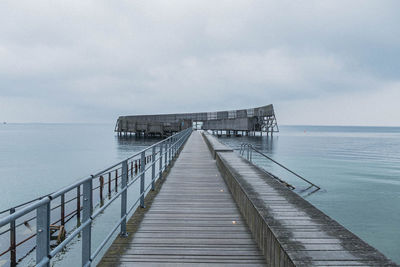 Pier over sea against sky