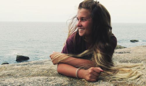 Portrait of smiling young woman on beach